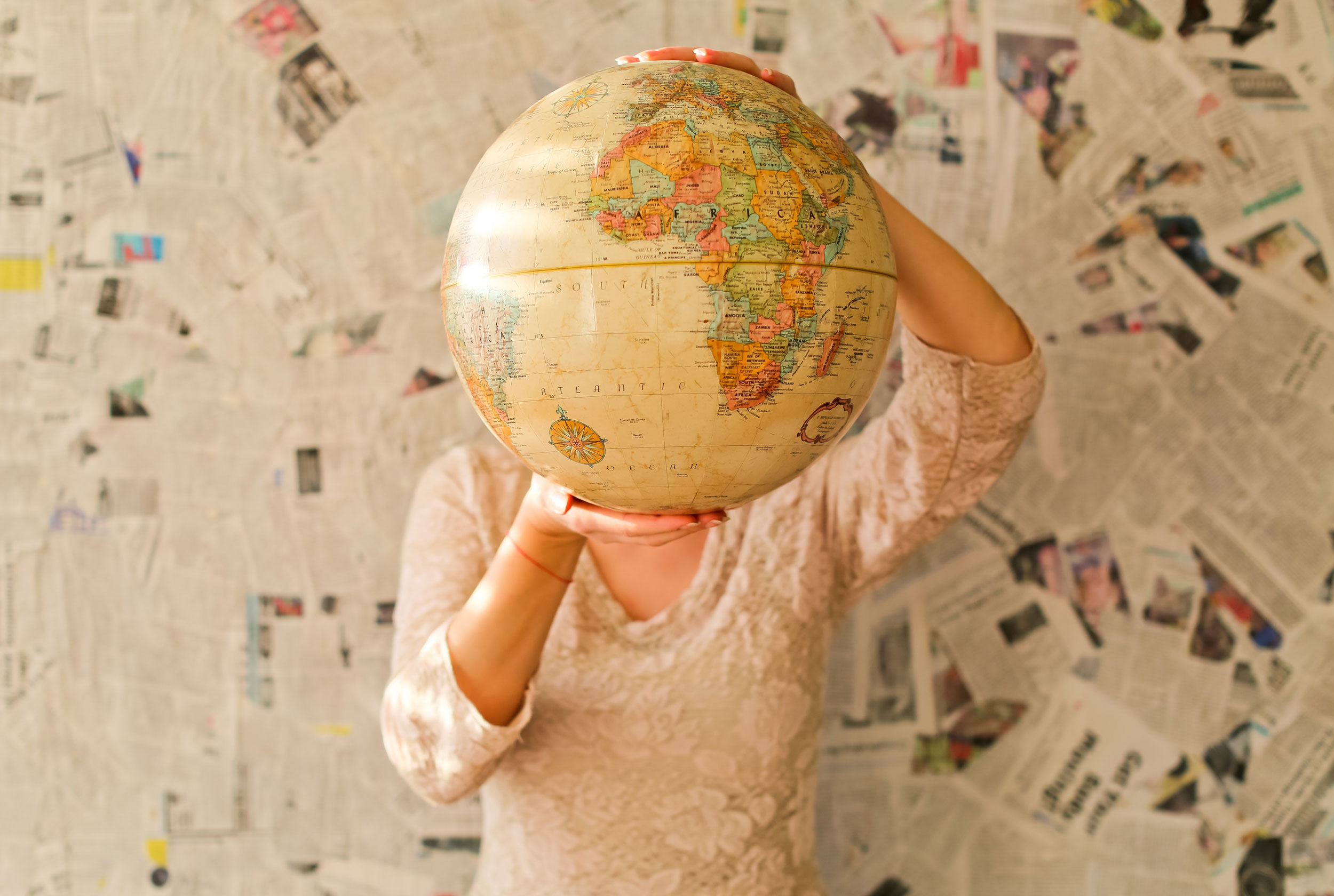 person-holding-globe